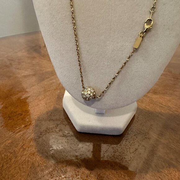 This necklace is a gold-tone with a rhinestone ball pendant. - Picture 6 of 7